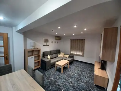 a living room with a couch and a table at piso tres habitaciones in Valencia