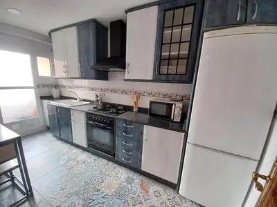a kitchen with white appliances and a white refrigerator at piso tres habitaciones in Valencia