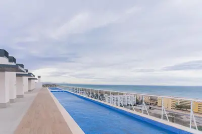 a view of the ocean from the balcony of a resort at Seaview Apartment in Canet with Rooftop Pool in Canet de Berenguer