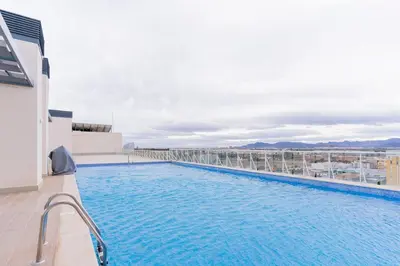 a swimming pool on the roof of a building at Seaview Apartment in Canet with Rooftop Pool in Canet de Berenguer