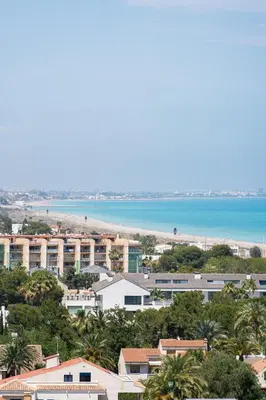 a view of a city with a beach and buildings at Seaview Apartment in Canet with Rooftop Pool in Canet de Berenguer