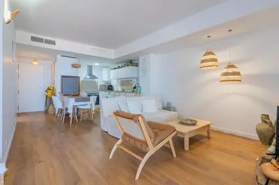 a living room with a couch and a table at Seaview Apartment in Canet with Rooftop Pool in Canet de Berenguer