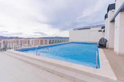 a swimming pool on the roof of a building at Seaview Apartment in Canet with Rooftop Pool in Canet de Berenguer