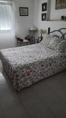 a bedroom with a bed with a floral bedspread at valenia city in Valencia