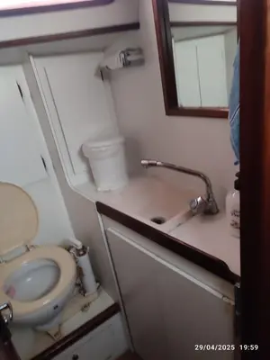 a small bathroom with a toilet and a sink at Romantic sailboat in Valencia