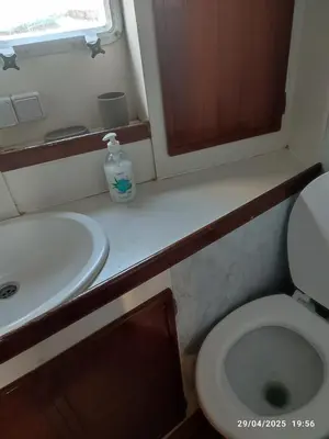 a small bathroom with a sink and a toilet at Romantic sailboat in Valencia