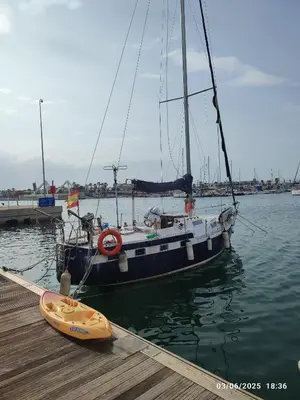 a sailboat is docked at a dock with a yellow kayak at Romantic sailboat in Valencia