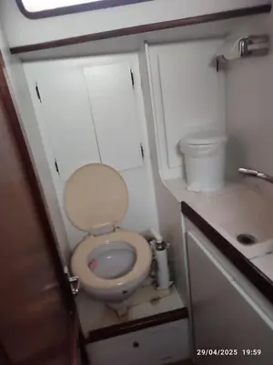 a small bathroom with a toilet and a sink at Romantic sailboat in Valencia