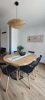 a dining room table with chairs and a potted plant at Casa Los Yayos in Segorbe