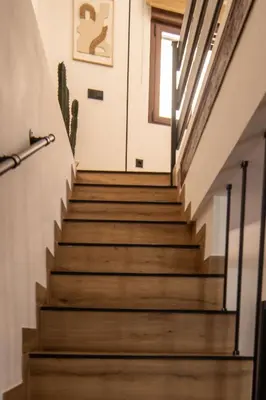 a staircase in a house with wooden floors at Casa Los Yayos in Segorbe