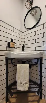 a bathroom with a sink with a towel under it at Casa Los Yayos in Segorbe
