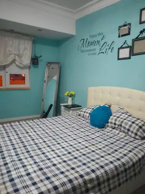 a bedroom with a bed with a blue and white checkered blanket at Vacansis Cullera Pintor Sorolla 2 in Cullera