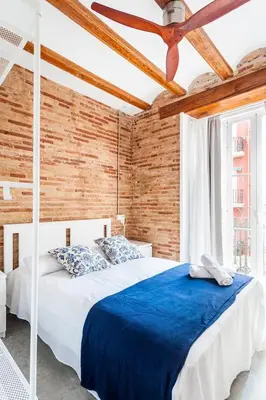 a bedroom with a bed and a ceiling fan at Ruzafa Confort 3 pax wifi Denia 70 in Valencia