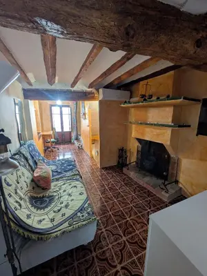 a living room with a couch and a fireplace at Casa rural El Mestre in Alcudia de Veo