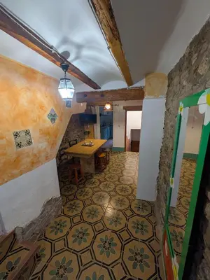 a room with a table and a tile floor at Casa rural El Mestre in Alcudia de Veo
