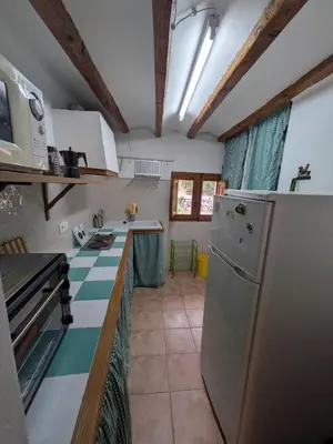 a kitchen with a refrigerator and a counter top at Casa rural El Mestre in Alcudia de Veo