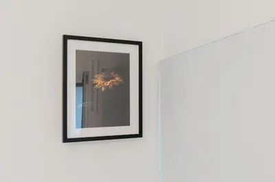 a picture hanging on a wall with a mirror at Travel Habitat Playa del Cabanyal in Valencia