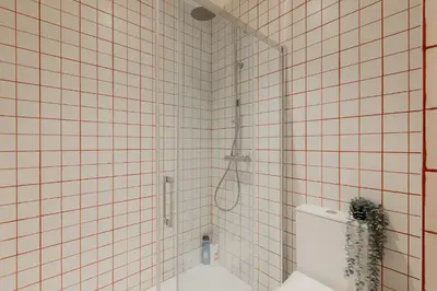 a bathroom with a shower with a toilet in it at Travel Habitat Playa del Cabanyal in Valencia