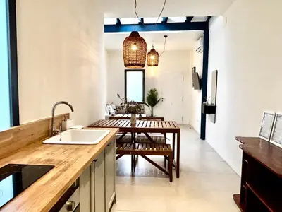 a kitchen with a table and a dining room at Travel Habitat Playa del Cabanyal in Valencia