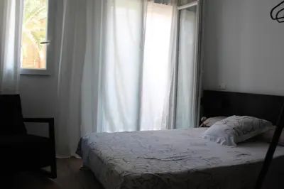 a bedroom with a bed and a window at Playa Cabañyal - Diseño Mediterraneo in Valencia