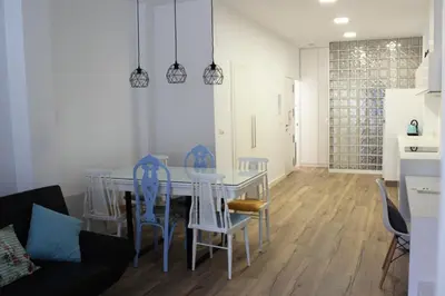 a kitchen and dining room with a table and chairs at Playa Cabañyal - Diseño Mediterraneo in Valencia