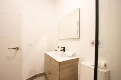 a bathroom with a sink and a mirror and a toilet at LObjet trouvé in Valencia