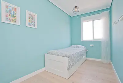 a bedroom with a bed in a room with blue walls at El Cabanyal - Mar y Atardecer in Valencia