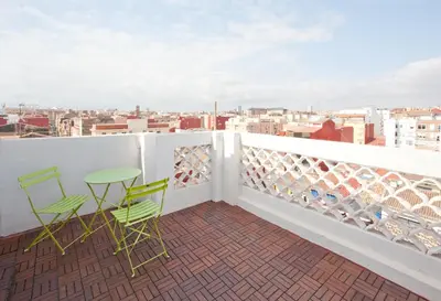a balcony with two chairs and a table on a roof at El Cabanyal - Mar y Atardecer in Valencia