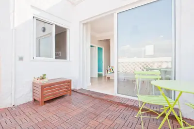 a living room with a table and chairs at El Cabanyal - Mar y Atardecer in Valencia