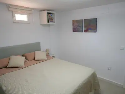 a bedroom with a bed with two pillows on it at Natural park, terrace and pool in Partida de La Cañada