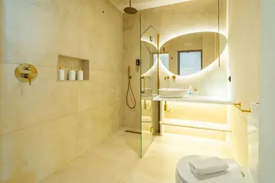 a bathroom with a shower and a sink and a mirror at Nomad HAUX Puerto in Valencia