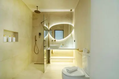 a bathroom with a toilet and a sink and a mirror at Nomad HAUX Puerto in Valencia