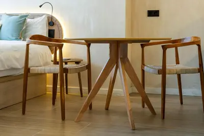 a wooden table and two chairs next to a bed at Nomad HAUX Puerto in Valencia
