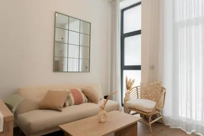 a living room with a couch and a table at Stylish downtown charm in Valencia