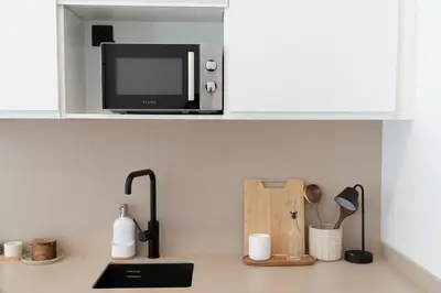a microwave oven sitting on top of a kitchen counter at Stylish downtown charm in Valencia