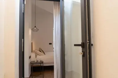 a door leading to a bedroom with a bed at Stylish downtown charm in Valencia
