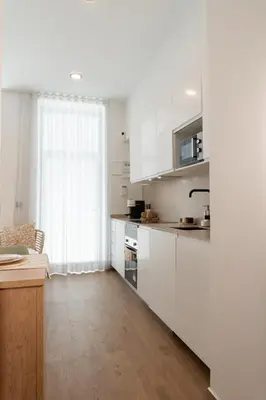 a kitchen with white cabinets and a window at Stylish downtown charm in Valencia