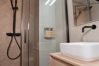 a bathroom with a sink and a shower at Stylish downtown charm in Valencia