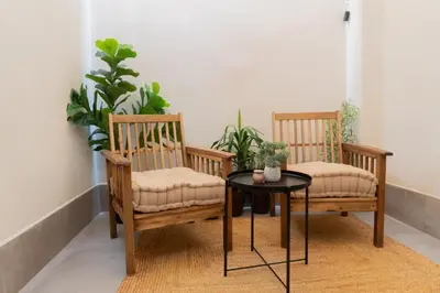 two chairs and a table in a room with plants at Stylish downtown charm in Valencia