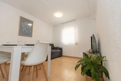 a living room with a white table and a couch at Bonito Apartamento Paterna 2 Dormitorios in Paterna