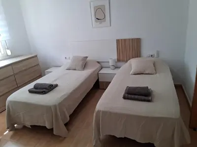two beds in a small room with towels on them at Bonito Apartamento Paterna 2 Dormitorios in Paterna