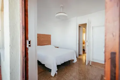 a bedroom with a white bed and a hallway at Garden at 50m from beach, ChillOut, Large Porche in Mareny Blau