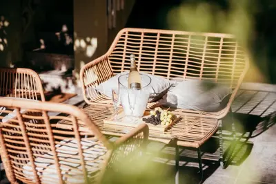 a wicker table and chairs with a drink on it at Garden at 50m from beach, ChillOut, Large Porche in Mareny Blau