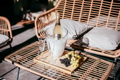 a bottle of wine and glasses on a table at Garden at 50m from beach, ChillOut, Large Porche in Mareny Blau