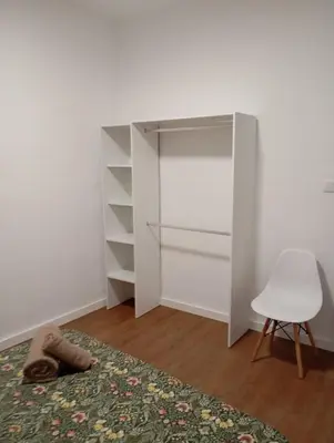 a room with a closet and a chair and a rug at Apartament El Colomer 3 habitacions in Simat de Valldigna