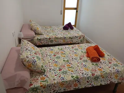 two twin beds in a room with a bedspread and pillows at Apartament El Colomer 3 habitacions in Simat de Valldigna