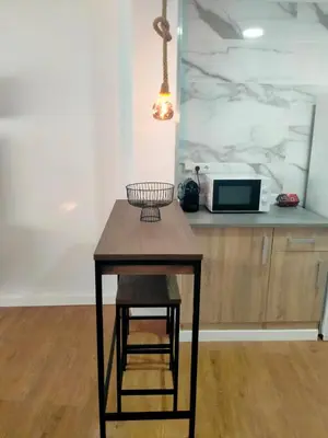 a small table with a stool in a kitchen at Apartament El Colomer 3 habitacions in Simat de Valldigna