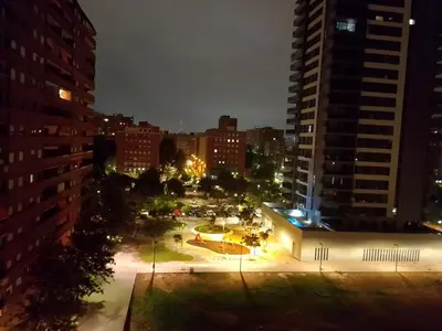 a view of a city at night with buildings at Habitación confortable in Valencia