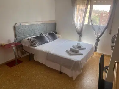 a bedroom with a bed with two towels on it at Habitación confortable in Valencia