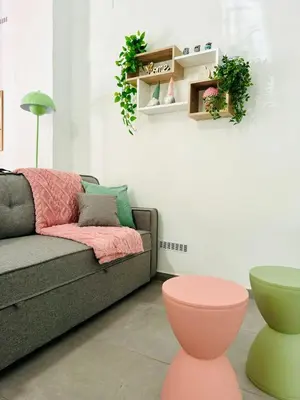 a living room with a couch and a pink stool at Cute & Cozy Aparment Near The Historic Center in Valencia